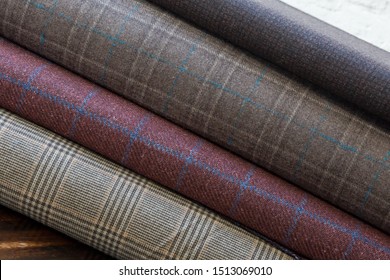 Rolls of fabric and textiles in atelier or store. Different fabric for business suit. Industrial fabrics. Closeup	
