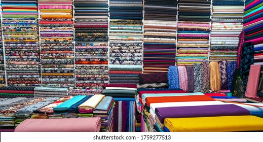 Rolls of fabric and textiles in a factory shop. Multi different colors and patterns on the market Fabrics in rolls. Fabric store in turkey