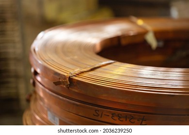Rolls of flat copper products close-up. Copper tape in bundles. Copper rolling.