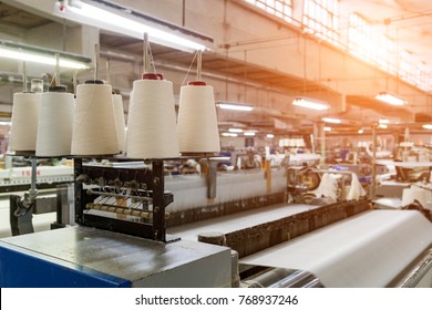 Rolls of industrial cotton fabric for clothing cloth textile manufacture on machine  - Shutterstock ID 768937246