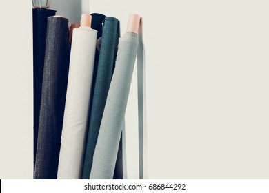 Rolls of natural high fashion fabrics and textiles. Sewing industry concept