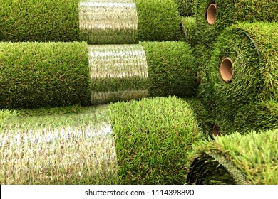 Rolls of new artificial grass in the shop
