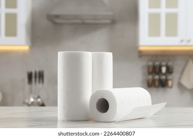 Rolls of paper towels on white marble table in kitchen