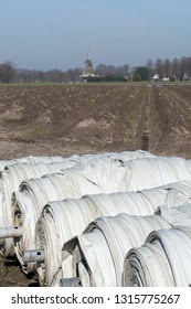 Rolls With Plastic Film For Covering White Asparagus Fields, Begin Of New Asparagus Season On Asparagus Farm In Netherlands, Country Spring Landscape With Traditional Dutch Mill