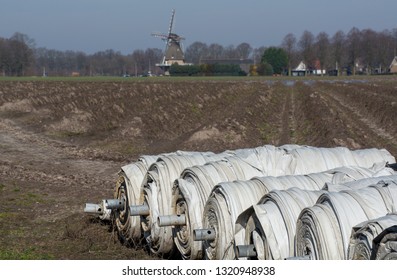 Rolls With Plastic Film For Covering White Asparagus Fields, Begin Of New Asparagus Season On Asparagus Farm In Netherlands, Country Spring Landscape With Traditional Dutch Mill