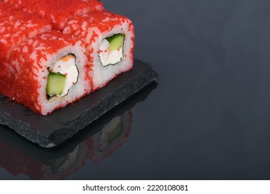 Rolls Of Red Flying Fish Caviar On A Dark Background