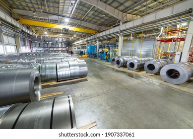 Rolls of sheet metal lie on the floor. Internal warehouse of raw materials.