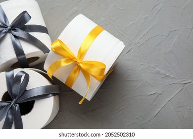 Rolls Of Toilet Paper With Ribbon On Dark Background