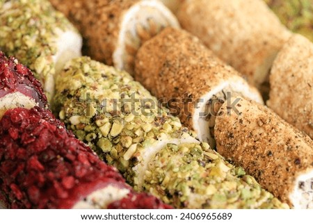 Rolls of turkish delight with many different flavors and fillings close up on table of vendors market bazaar