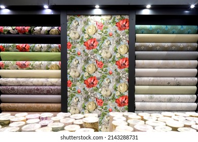 Rolls of vinyl wallpaper in building materials store. Various textures and colors as background. Wallpaper with floral pattern for wall, repair materials. - Shutterstock ID 2143288731