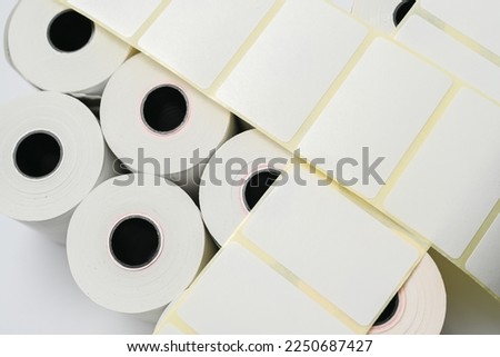 Rolls of white labels isolated. Labels for direct thermal or thermal transfer printing. Blank sticky label roll for thermal transfer printing pirce criss the brand for labels, labelers self-adhesiv
