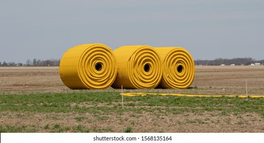 Rolls Of Yellow Farm Drainage Pipe.