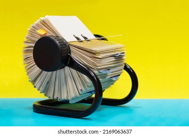 Rolodex file organizer sitting open on a colorful plain background with copy space. - Shutterstock ID 2169063637