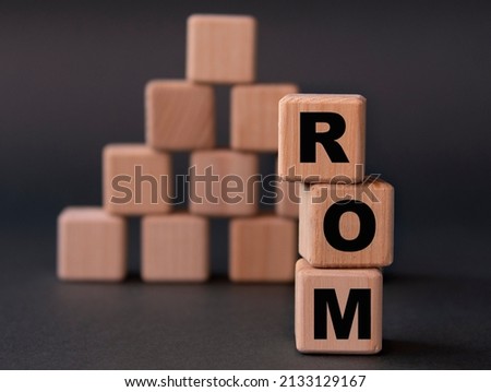 ROM (Read only memory) - acronym on wooden cubes on a dark background. Business concept