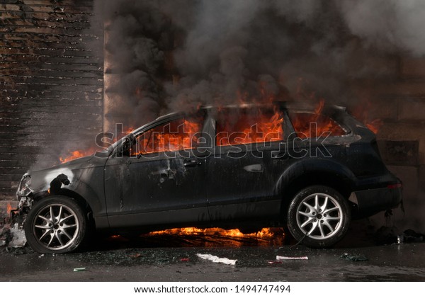 Roma,Lazio Region,Italy,10/15/2011:Car on fire\
in Rome on Via Cavour, set on fire at the beginning of the event\
held in Rome on\
10/15/2011