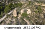 The Roman Aqueduct of Pena Cortada located near Valencia, Spain is a colossal work of hydraulic engineering built in the 1st century AD.