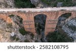 The Roman Aqueduct of Pena Cortada located near Valencia, Spain is a colossal work of hydraulic engineering built in the 1st century AD.