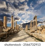 Roman Columns in the Jordanian city of Jerash (Gerasa of Antiquity), capital and largest city of Jerash Governorate, Jordan. Against the background of a beautiful sky with clouds 