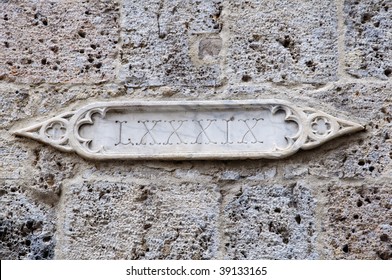 Roman Numerals On Wall Of Old Building - Siena, Italy