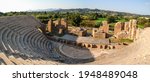 Roman Odeum Of Nicopolis ancient cultural landmark in Greece wide panorama. Marble historical theater construction, panoramic view on stage in center. Travel Europe