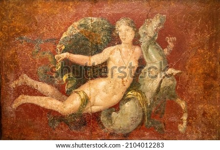 Roman Pompeian fresco representing mythological figures in Naples, Italy