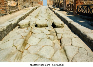 Roman Street In Pompeii With Chariot Grooves In The Stone And Stepping Stones For Pedestrians