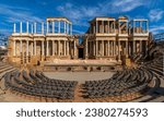 Mérida Roman theater from behind with a view of the chairs, granite steps and the stage scaenae frons of classical Roman columns and statues for the Merida International Classical Theater Festival.