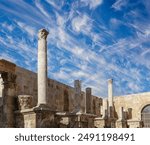 Roman Theatre in Amman, Jordan -- theatre was built the reign of Antonius Pius (138-161 CE), the large and steeply raked structure could seat about 6000 people. Against the sky with clouds 