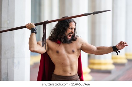 Roman Warrior Attacks With A Spear. Screams. 