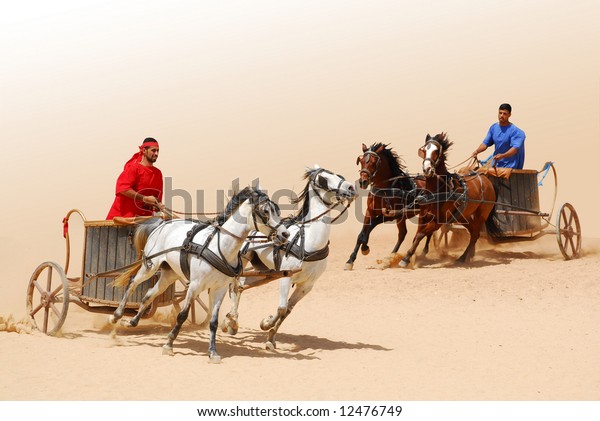 Roman warriors racing with horses and\
chariots carts during Roman show in Jerash,\
Jordan