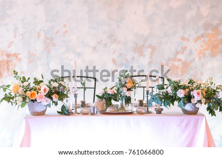 romance, dating, table setting concept. the most perfect table setting for romantic evening for couple, plenty of flowers in big and tiny bunches, numbers of candles in various holders and dishes