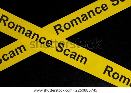 Romance scam alert, caution and warning concept. Yellow barricade tape with word in dark black background.