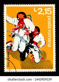 ROMANIA - CIRCA 1977: A postage stamp printed in Romania shows two men wearing traditional costume performing a folk dance known as "Dansul Calusului". This ritual dance is performed on Whit Sunday.