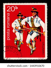 ROMANIA - CIRCA 1977: A postage stamp printed in Romania shows two men wearing traditional costume performing a folk dance known as "Dansul Calusului". This ritual dance is performed on Whit Sunday.