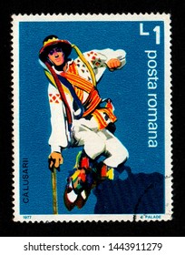 ROMANIA - CIRCA 1977: A postage stamp printed in Romania shows a man wearing traditional costume performing a folk dance known as "Dansul Calusului". This ritual dance is performed on Whit Sunday.