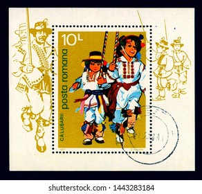 ROMANIA - CIRCA 1977: A stamp printed in Romania shows two young boys wearing traditional costume performing a folk dance known as "Dansul Calusului". This ritual dance is performed on Whit Sunday.