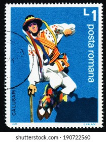 ROMANIA - CIRCA 1977: A stamp printed in Romania from the "Calusarii Folk Dance" issue shows leaping dancer with stick, circa 1977.