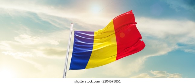 Romania national flag waving in beautiful sky.