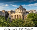 Romanian Atheneum in Bucharest during a summer sunset. Aerial view of this amazing landmark historical building from Bucharest, Romania, on Victoriei Avenue (Calea Victoriei). Travel to Romania.