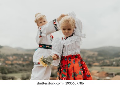 Romanian Girl And Boy In Tradițional Clothes Dancing