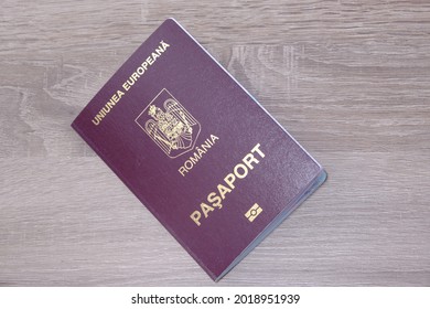 Romanian Passport On A Wooden Table Front Side