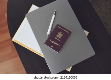 Romanian Red Passport Isolated On Laptop