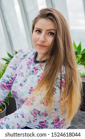 Romanian Women Wearing A Pullover With Flower Pattern Surrounded By Plants