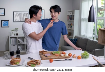 Romantic Asian Gay Couple Cooking On Kitchen. Lgbt Men Couple Are Having Fun Together While Preparing Healthy Food. Healthy Lifestyle Concept.