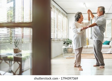 Romantic Asian Senior couple dancing at home. Happy Smiling Grandfather and Grandmother having fun Celebrating in wedding Anniversary day. Elderly man and woman holding hands together, Romance, lover - Powered by Shutterstock