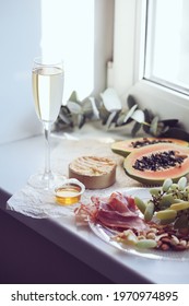 Romantic Authentic Home Indoor Picnic, Champagne Glass, Papaya, Camembert Cheese, Jamon And Nuts, Eucalyptus Branch