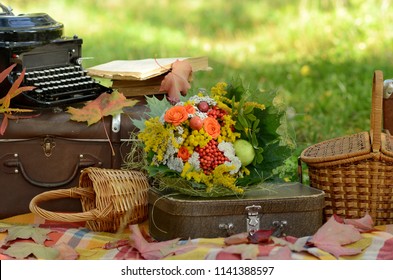 Romantic autumn still life with books, plaid, vintage suitcase, old typewriter  and leaves - Powered by Shutterstock