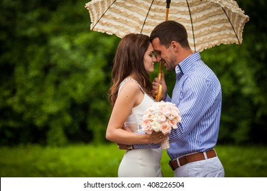 Romantic beautiful couple hugging under elegant umbrella outdoors - Powered by Shutterstock