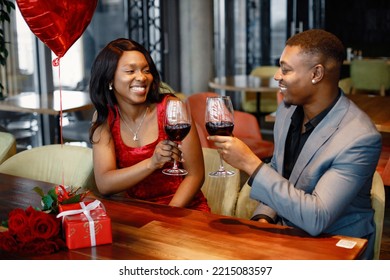 Romantic black couple sitting at restaurant wearing elegant clothes - Powered by Shutterstock