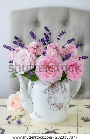 Similar – Woman makes festive bouquet with vase